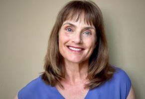 Head shot of Dr. Leslie Ellis, smiling, in a blue t-shirt