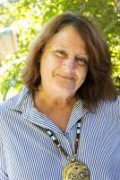 Woman with brown hair in sunshine